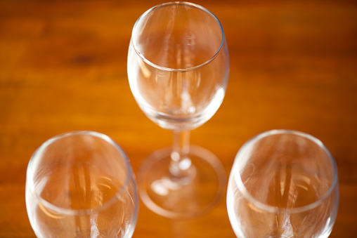 Two glasses: with liquid and spilled liquid isolated on white background