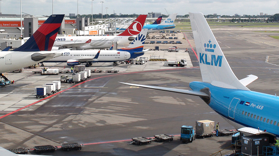 Passengers Airline From Different Company Packed At Loading, Unloading Gate Of Amsterdam Schiphol International Airport In The Netherlands Europe
