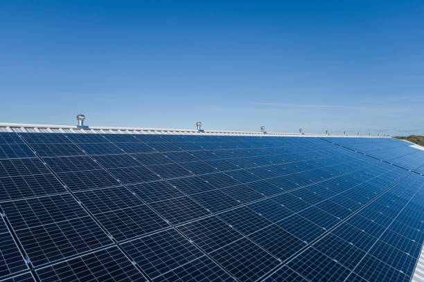 istock Solar panel on a farm roof. Drone point of view. Clear Blue Sky 1461348503