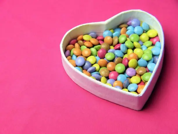 colorful chocolate candies in a love shaped box