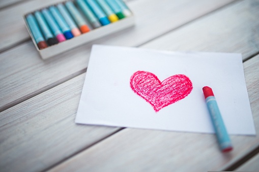 draw a pink heart on white paper using crayons