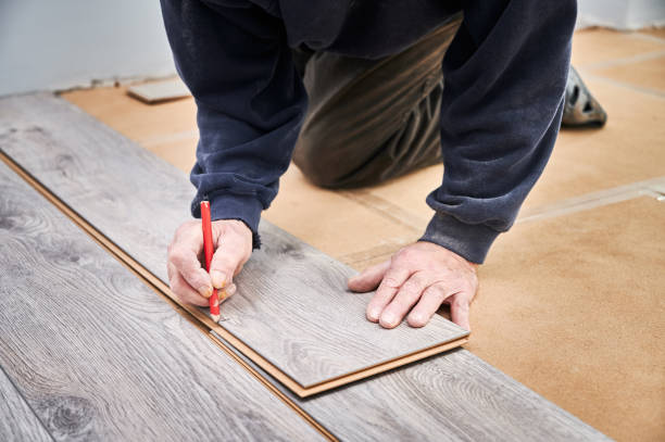 istock Male worker hands drawing mark on laminate plank. 1461350936