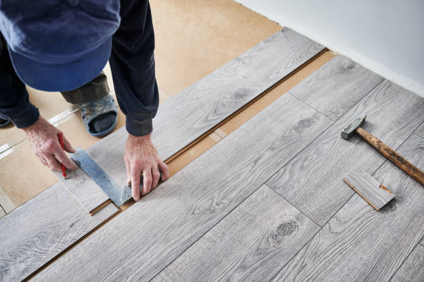 istock Male worker hands drawing straight line on laminate plank. 1461350995