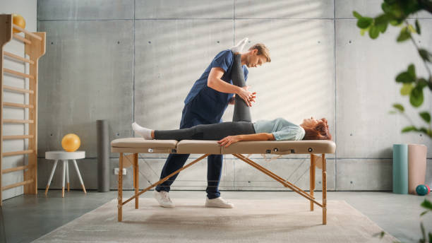 istock Advanced Sport Physiotherapy Specialist Stretching and Working on Specific Muscle Groups or Joints with Elderly Woman. MIddle Aged Female Recovering from Mild Injury, Undergoing Rehabilitation. 1461351893