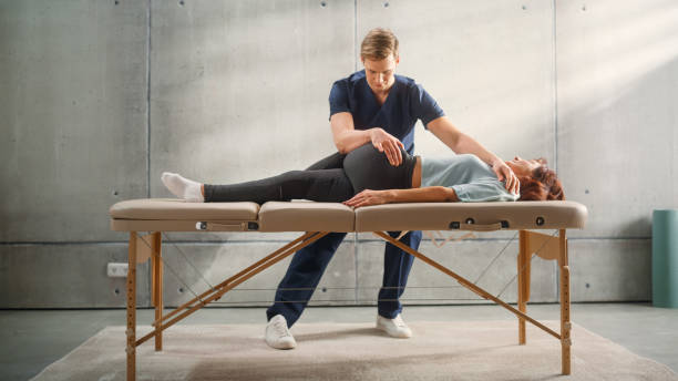 istock Professional Sport Physiotherapist Working on Specific Muscle Groups or Joints with Middle Aged Fit Female. Senior Woman Recovering from Mild Injury. Trauma Therapy or Rehabilitation. 1461352731