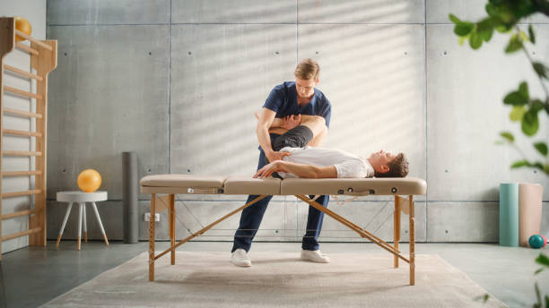 istock Professional Sport Physiotherapist Working on Specific Muscle Groups or Joints with Young Male Athlete. Sportsman Recovering from Injury. Trauma Prevention Therapy or Rehabilitation. 1461352784