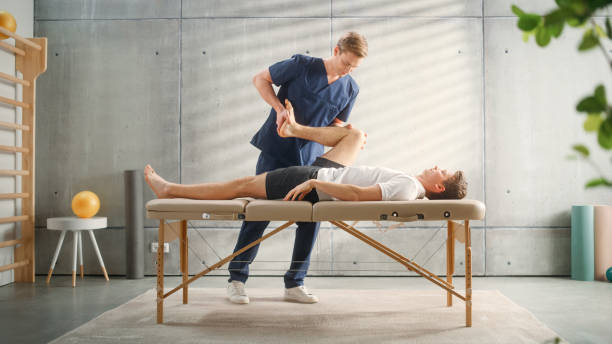istock Professional Sport Physiotherapist Working on Specific Muscle Groups or Joints with Young Male Athlete. Sportsman Recovering from Mild Injury. Trauma Prevention Therapy or Rehabilitation. 1461352803