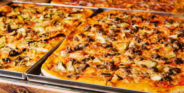 istock Tasty square pizzas on metal trays 1461355971