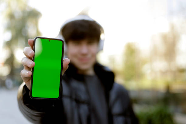 istock teenager showing cell phone screen to camera 1461355980
