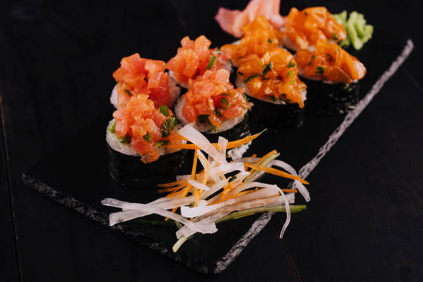 istock sushi maki rolls with sliced salmon on top 1461357010