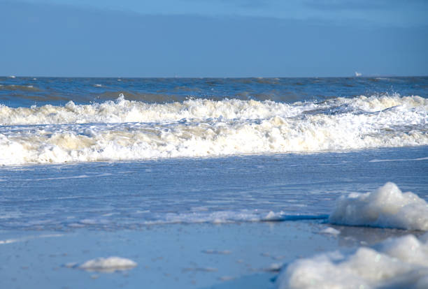 istock foam from some waves at the lonely beach 1461357923