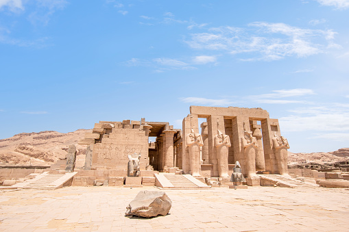 Ramesseum, Theban Necropolis, Luxor, Egypt - July 27, 2022:  The Ramesseum is the memorial temple (or mortuary temple) of Pharaoh Ramesses II. It is located in the Theban Necropolis in Upper Egypt, on the west of the River Nile, across from the modern city of Luxor. The name – or at least its French form Rhamesséion – was coined by Jean-François Champollion, who visited the ruins of the site in 1829 and first identified the hieroglyphs making up Ramesses's names and titles on the walls.