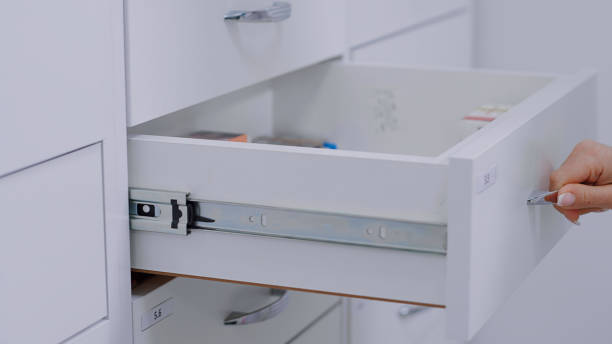 istock Pharmacist opens one of the white drawers with medicines 1461358446