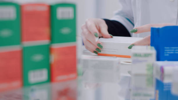 istock Pharmacist puts price tags on medicines 1461358575