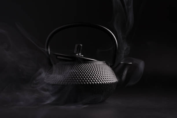 istock Black japanese cast iron teapot with steam 1461358658