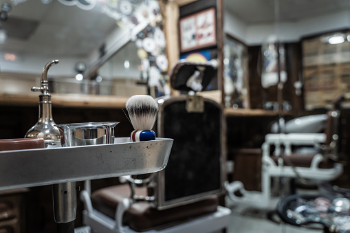 Selective focus on a plate with some barber tools in an empty barbershop