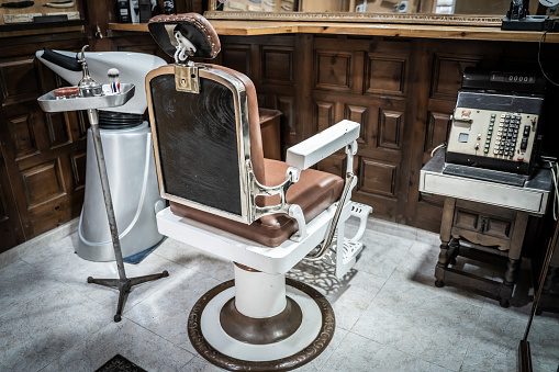Rear view of a retro chair in an empty barber shop