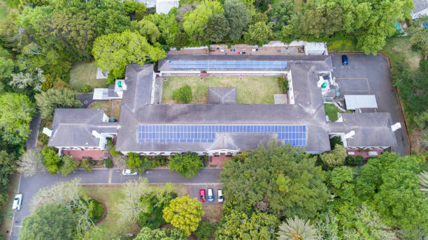istock Large roof with solar panels surrounded by trees 1461359348