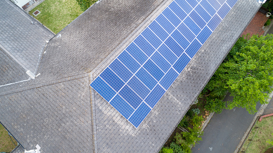 Aerial view of new solar panels on roof of large old building. college hall of residency.