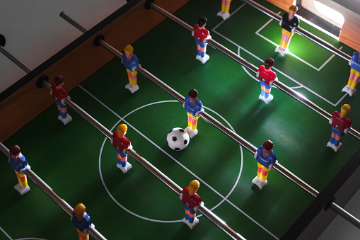 Close-up view of a table football game in progress creates a sense of excitement and competition