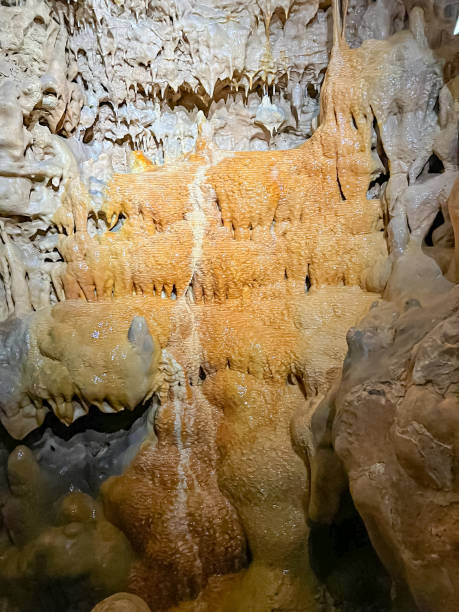 istock Cavern with many stalactites and stalagmites, texture, water cascade with stalactites 1461360919