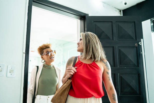 istock Friends talking while entering in a house 1461361255