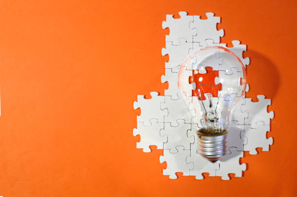 istock Business concept,recruiting,human resources,innovation, team building.Light bulb and jigsaw puzzle with one piece missing. Free copy space. 1461361515