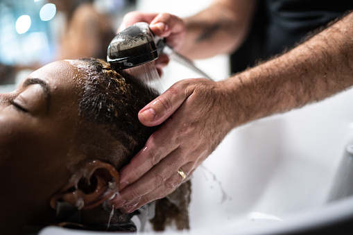 Hairdresser washing a woman's hair at a hair salon