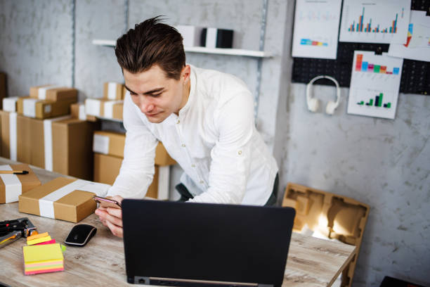 istock Smiling young man surfing the net on smartphone 1461362574