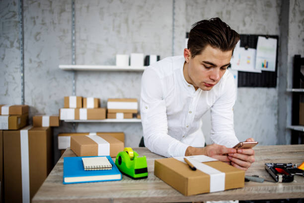 istock Young man takes orders from customers while working in online store 1461362585