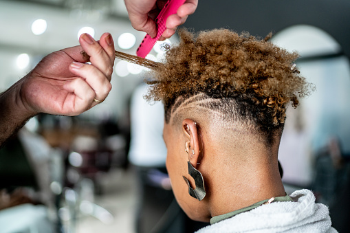 Hairdresser styling a woman's hair at a hair salon