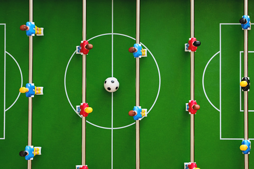 Top view of a table football game in progress creates a sense of excitement and competition