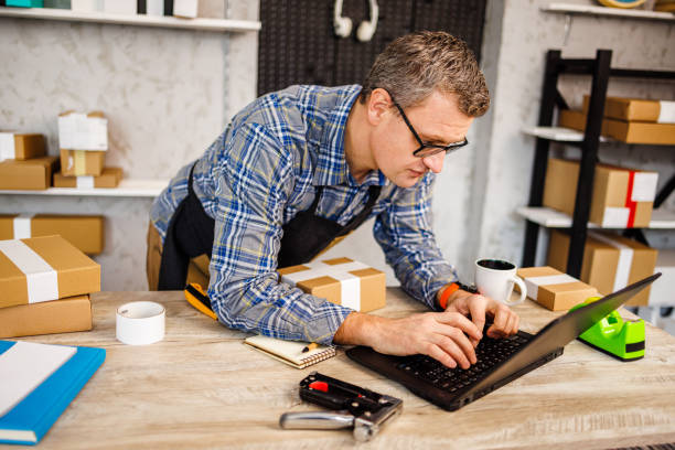 istock Man works on laptop in retail place 1461363276