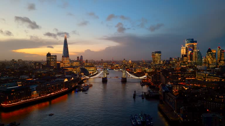 Aerial view of London skyline featuring the Shard, Tower Bridge and River Thames at twilight - 4k video