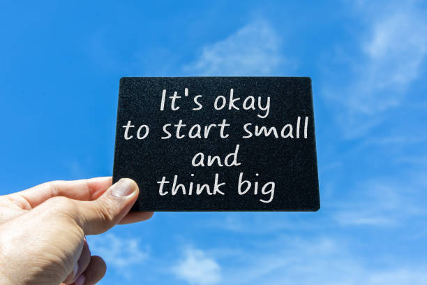 istock It's okay to start small and think big. Text on card with clouds and sky background. Inspirational motivational quote. 1461363399