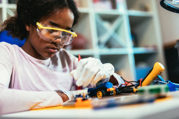istock Girl is Working on a Robot in Her Room. 1461365414