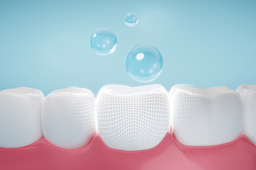 Drop of fluoride coating teeth and gums metaphor oral hygiene, cleaning teeth and gums. 3D rendering.