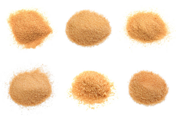 istock Piles of brown sugar on white background, top view 1461367898