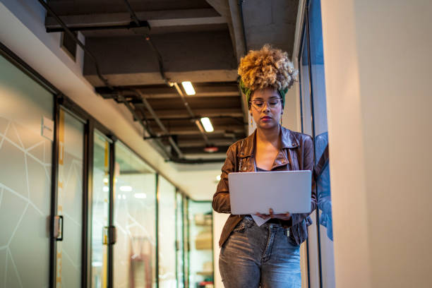 istock Latin woman is working at office with her laptop 1461368204