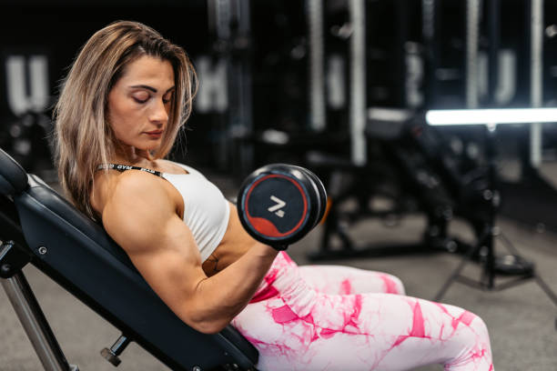 istock Young Woman Training With Dumbbells At The Gym 1461372261