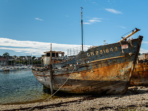 Camaret-sur-Mer, France - August, 20 2020: Old rusty boats in the boat cemetery, sunny day in summer