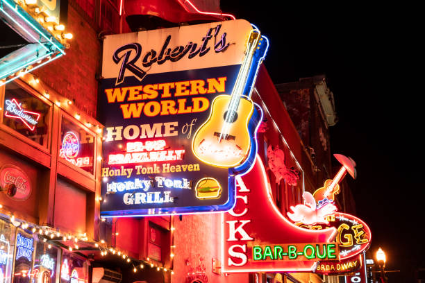 Nashville Tennessee Night Street Scene Nashville, Tennesee, United States - January 21, 2023: Street scene from famous lower Broadway in Nashville Tennessee viewed at night with lights, historic honky-tonks, bars and restaurants. nashville stock pictures, royalty-free photos & images