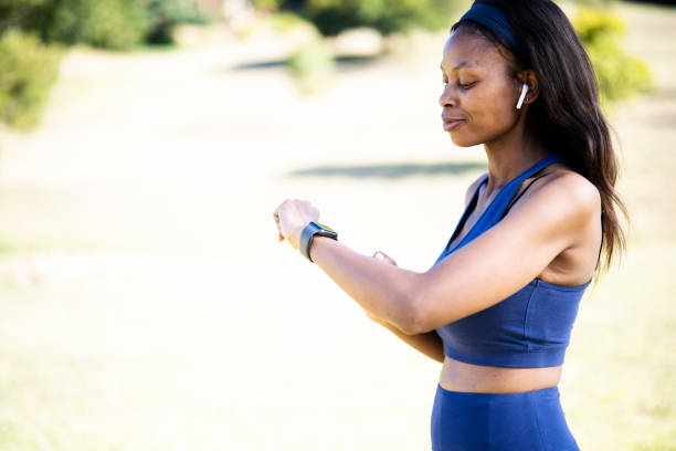 istock Side view woman exercising using smart watch and wireless headphones 1461373118