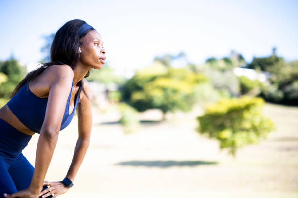 istock Side view determined sportswoman looking up in resting position 1461373130