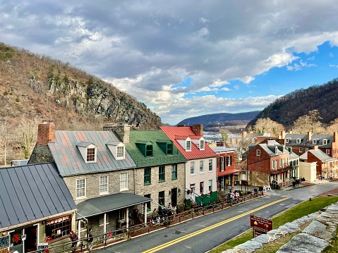 Harpers Ferry, West Virginia, USA - Historic Downtown in Harpers Ferry, West Virginia with people visible. This pedestrian friendly historic landmark is home to a collection of many shops and restaurants located in the historic buildings on and around National Park property.