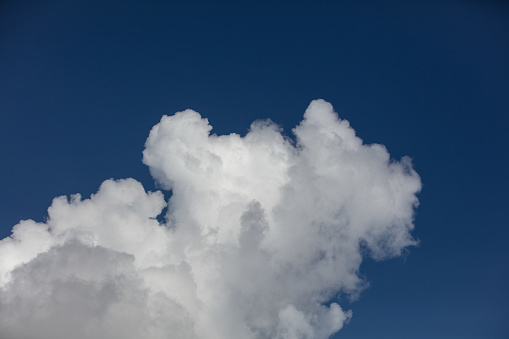 Cumulus clouds are clouds which have flat bases and are often described as \