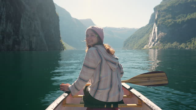 Woman canoeing on the lake in Norway
