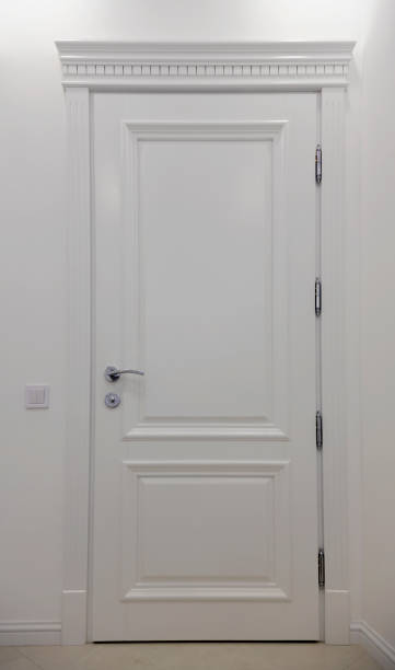 istock White modern wooden door. Interior door on a white wall. 1461379901