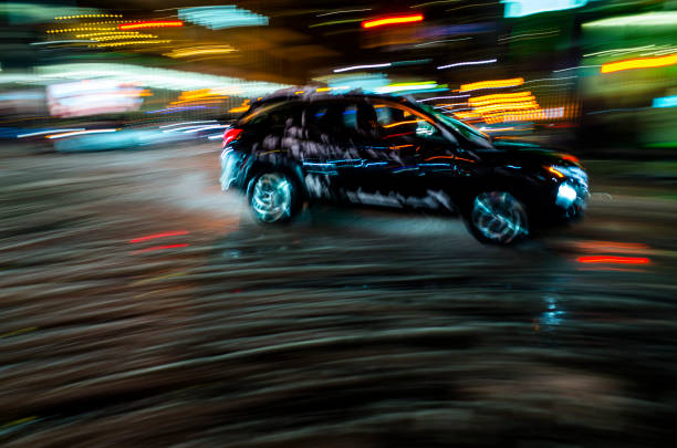 Blurred motion: Car and driver in silhouette