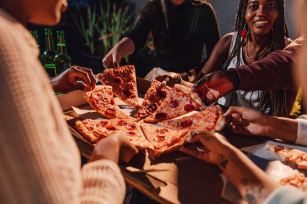 istock Friends eating pepperoni pizza on a party 1461385877